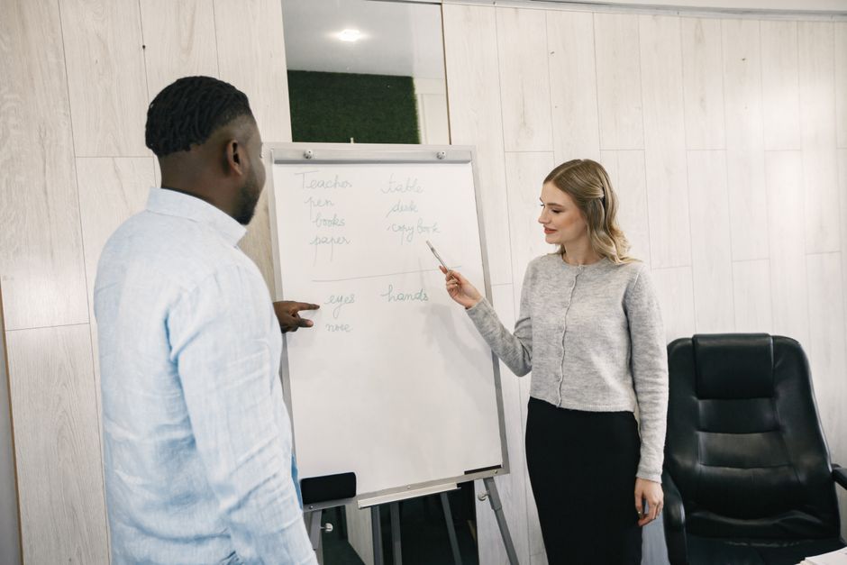 A diverse team having a discussion in front of a flip chart inside an office.